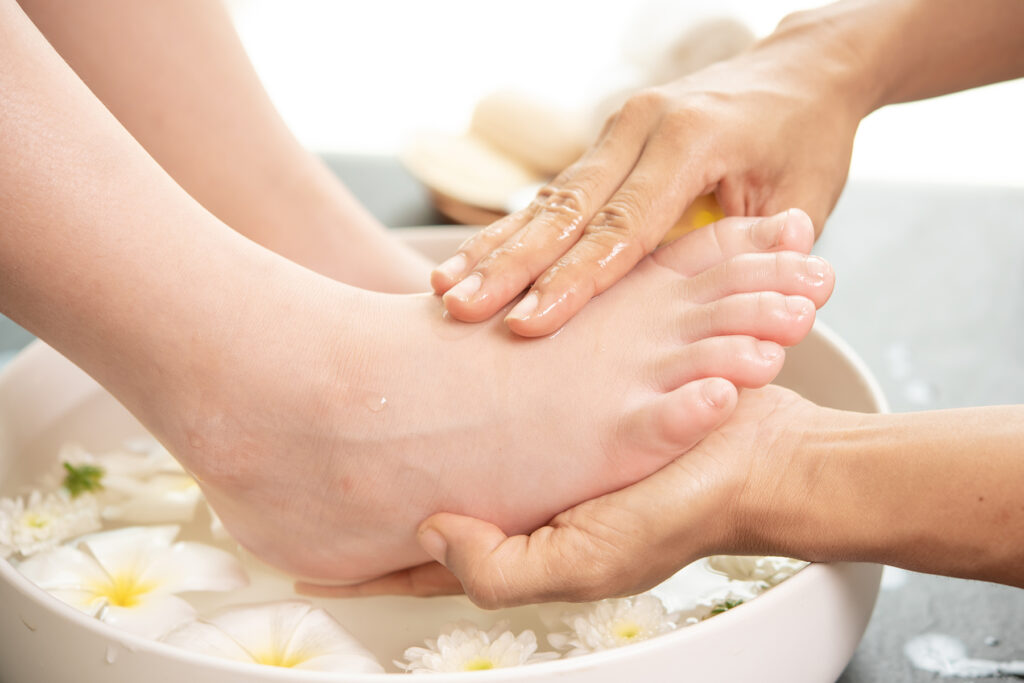 female-feet-soaking-mineral-salts-before-hand-and-foot-treatment-spa-session-1024x683